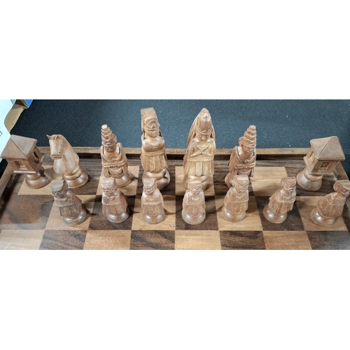 191 - Superb chess board with hand-carved Oriental wooden figures with fold-up carry board, also carved wo... 