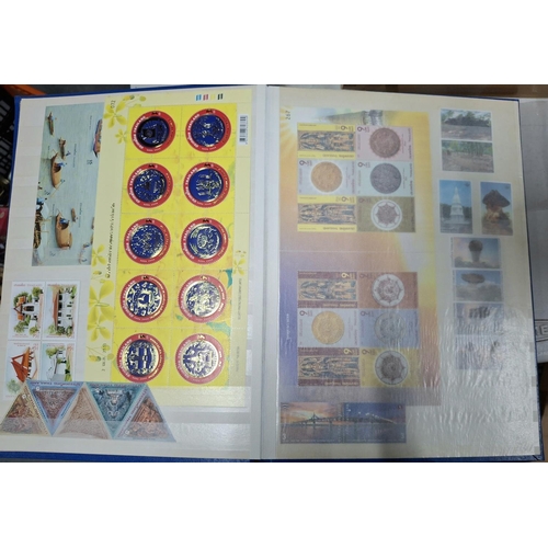 260A - Blue stock book containing a large quantity of modern mint unmounted Thailand and Malaysia stamp set... 