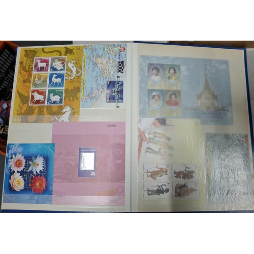 260A - Blue stock book containing a large quantity of modern mint unmounted Thailand and Malaysia stamp set... 