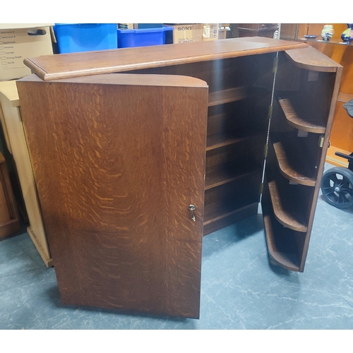 512 - Oak fold-out bookcase/drinks cabinet on castors