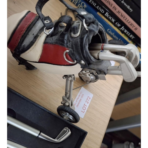 272 - Two sets of pens in the form of golf clubs, together with a pen holder in the form of a golf bag and... 