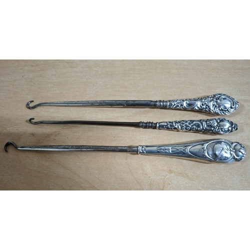 19 - Three antique silver handled button-hooks (3)