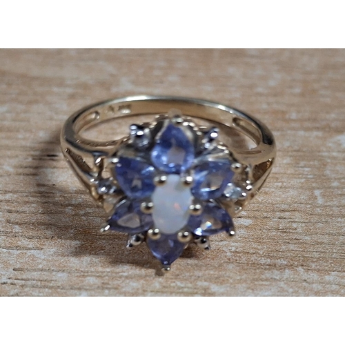 45 - Flower ring with a central oval cut Opal surrounded by Amethyst petals on a yellow gold coloured sha... 