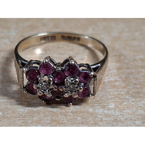 48 - Hallmarked 9ct yellow gold double flower ring with central diamonds flanked by Ruby petals,

2.7 gra... 