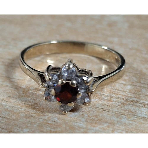 61 - Hallmarked 9ct yellow gold flower pattern dress ring with central Garnet,

2 grams gross            ... 