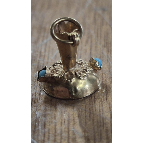 44 - 9ct gold bracelet charm in the shape of an old jug