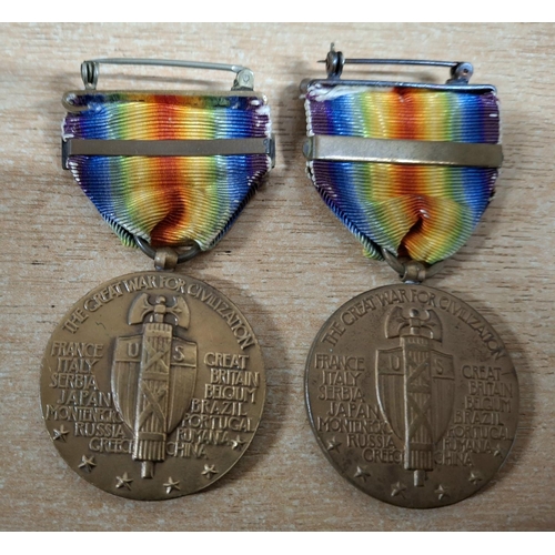 109 - Two USA WWI Victory medals, both with a bar, one for 