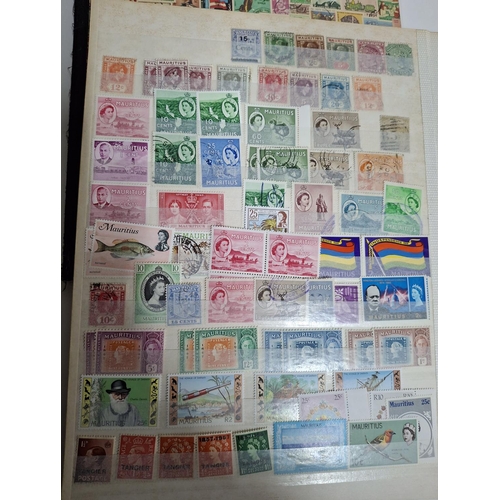 323 - Three albums containing a good collection of world and Commonwealth 20thC stamps, Hong Kong, Holland... 