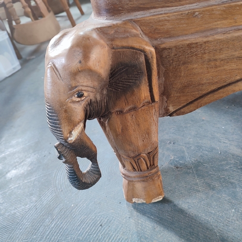 466 - A stunning hand-carved wooden coffee table with Elephant depictions to all four corners