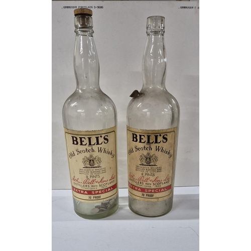 86 - Two 8 pint Bells Whisky bottles, one with a stopper and one with a small amount of GB coins (2)