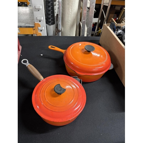 106 - Two orange Le Creuset lidded pans (2)