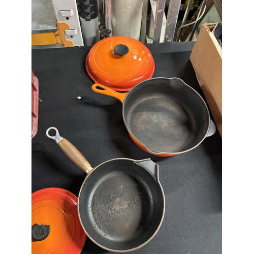 106 - Two orange Le Creuset lidded pans (2)