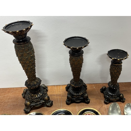 134 - Three different sized candle holders including cutlery and plates. One spoon is silver 16g