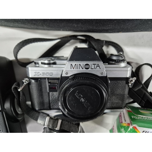 220 - Minolta X-300 with lense and flash together with a carry case