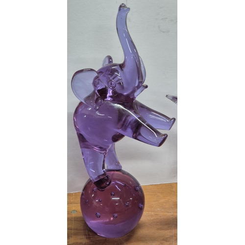 309 - Three huge (approx 46cm tall) purple glass, Elephant, bird and fish figurines, indistinctly signed t... 