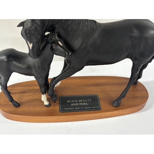 325 - Beswick Black beauty and foal on stand