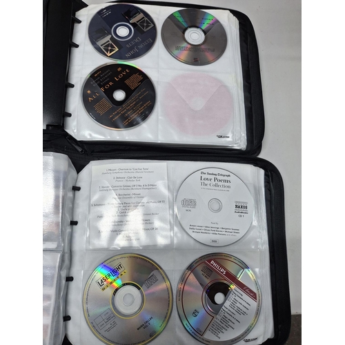 44 - Two Case Logic CD casers, both crammed full with music and audio story CDs (Qty)