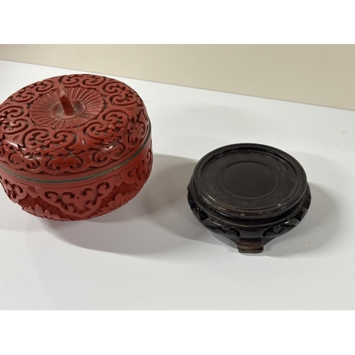 66 - Lidded squat cinnabar jar on a wooden stand