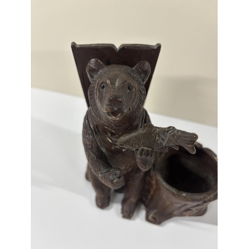 72 - Early 20thC Black Forrest carving with seated Bear next to a large basket, eating a fish,

The size ... 