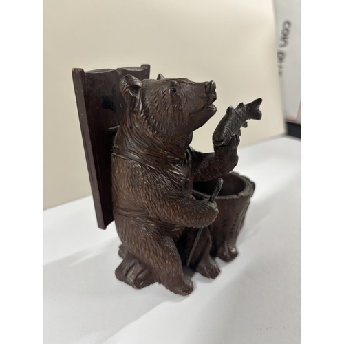 72 - Early 20thC Black Forrest carving with seated Bear next to a large basket, eating a fish,

The size ... 