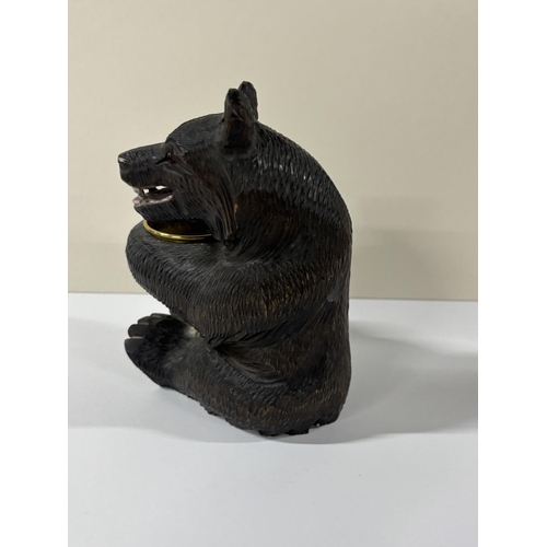 75 - Early 20thC Black Forrest carving with seated Bear holding an unmarked gilt metal  bowl, the bear is... 