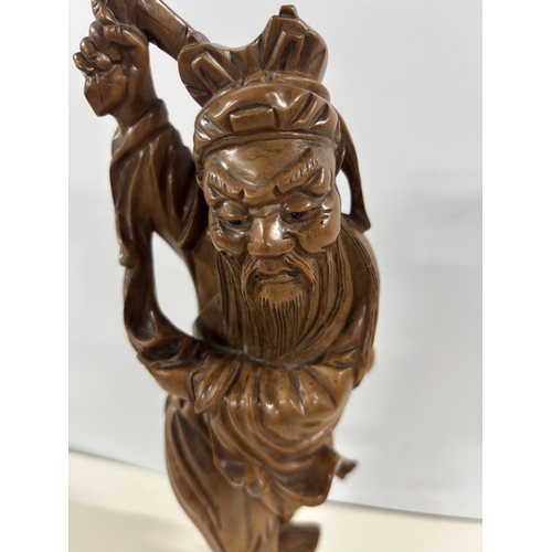 86 - 19thC Chinese root carving depicting an old man on an ebonised wood plinth,

The carving is approx 3... 