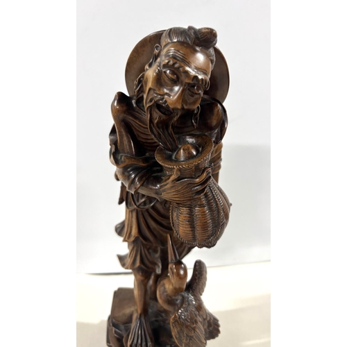 87 - 19thC Chinese root carving depicting an old man carrying a basket whilst walking on an rocky path wi... 