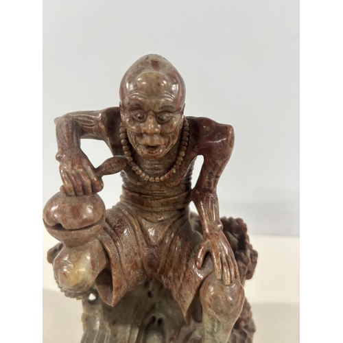 90 - Fine quality 19thC Chinese soapstone carving of a squatting man,

The carving measures approx 17cm t... 