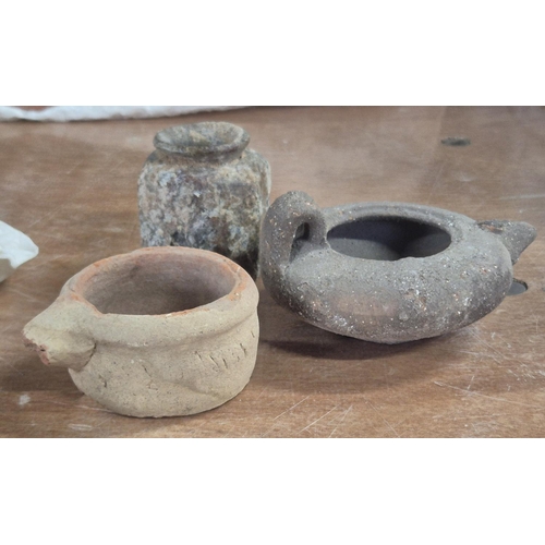 53 - Three Roman era items to include a terracotta oil lamp, the top portion and handle off a large ampho... 