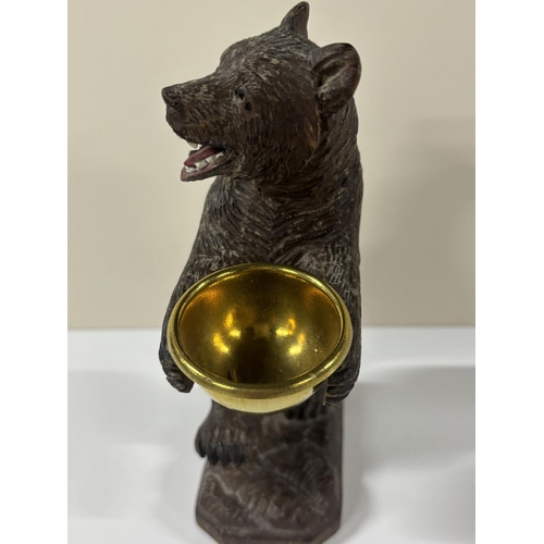 73 - Early 20thC Black Forrest carving with standing Bear holding a gilt metal bowl,

The size is approx ... 