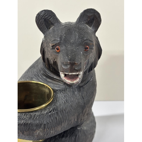 75 - Early 20thC Black Forrest carving with seated Bear holding an unmarked gilt metal  bowl, the bear is... 