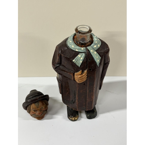 77 - Early 20thC Black Forest carving of a peasant man, the head is removable to reveal the neck of a gla... 