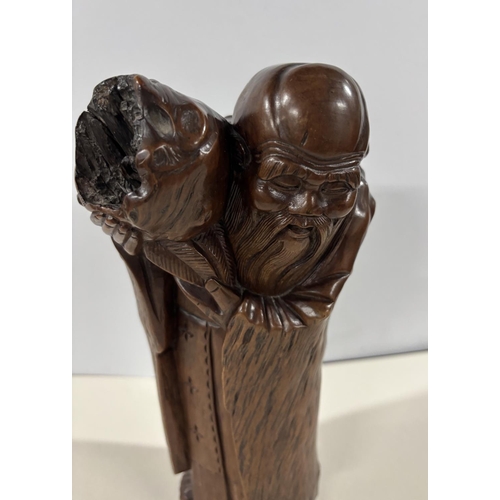 84 - Antique Chinese root carving depicting an old man carrying a package on his shoulders,

The carving ... 