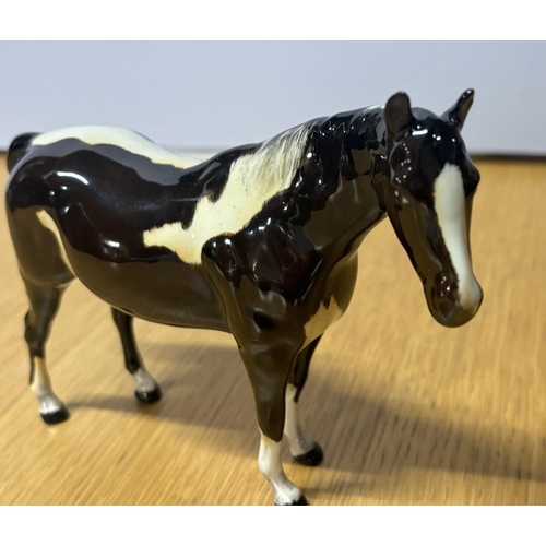 190 - Beswick Pinto Pony with possibly colour bleeding,

17cm long X 12.5cm high