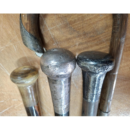 265 - Three silver topped Victorian canes together with a Victorian horn cane (4)