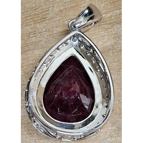 267 - Stunning Platinum pendant, 4-claw set with a large VS1 pear-shaped 80carat Ruby within a platinum su... 