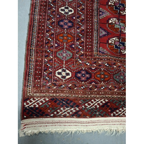 213 - Superb quality red ground woven wool patterned rug with short white tasselled ends, possibly middle-... 