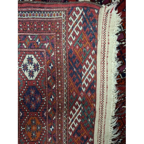 213 - Superb quality red ground woven wool patterned rug with short white tasselled ends, possibly middle-... 