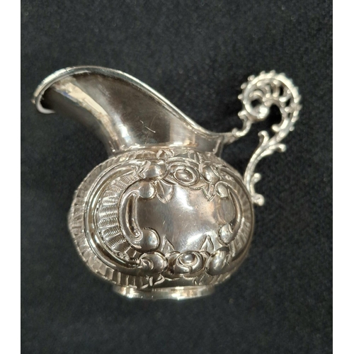 11 - Small ornately decorated, indistinctly hallmarked silver milk jug,

44 grams