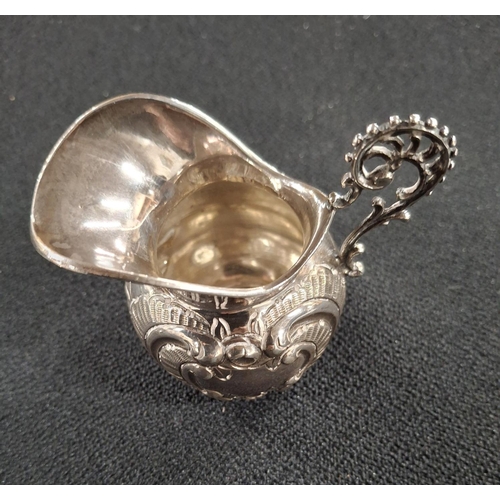 11 - Small ornately decorated, indistinctly hallmarked silver milk jug,

44 grams