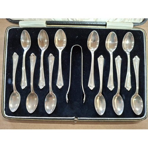 17 - Cased set of 12 hallmarked 1924 Birmingham silver tea spoons together with a sugar nip,

155 grams