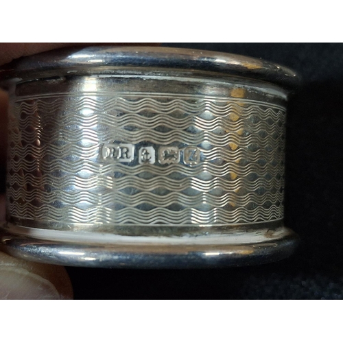 23 - Pair of Birmingham hallmarked silver napkin rings with engine turned decoration together with 2 othe... 