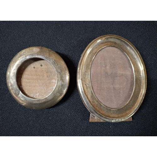 26 - Four small Edwardian free-standing oval and circular silver photo frames (4)