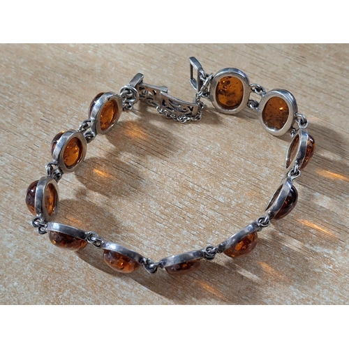 31 - Ladies 925 stamped silver bracelet with 11 Amber cabochons