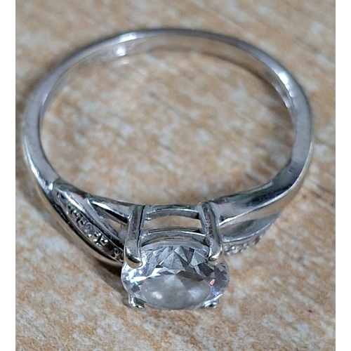 39 - 9ct white gold ring with a large CZ and smaller stones to both shoulders,

2.4 grams gross