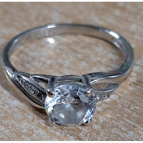39 - 9ct white gold ring with a large CZ and smaller stones to both shoulders,

2.4 grams gross