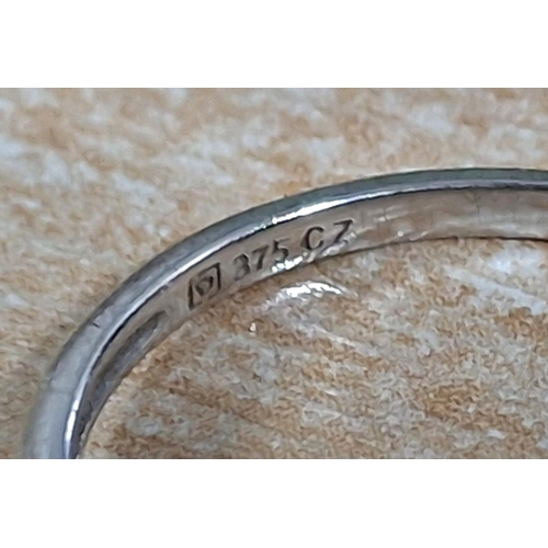 39 - 9ct white gold ring with a large CZ and smaller stones to both shoulders,

2.4 grams gross
