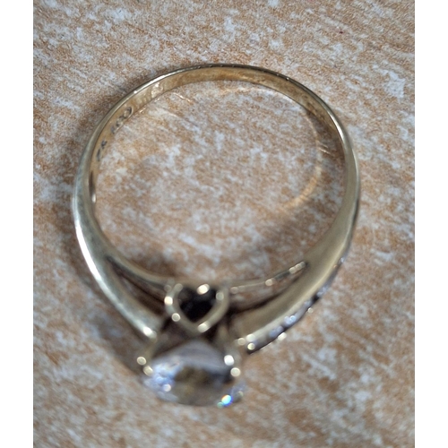 40 - 9ct yellow gold ring with a large CZ and smaller stones to both shoulders, 

3 grams gross