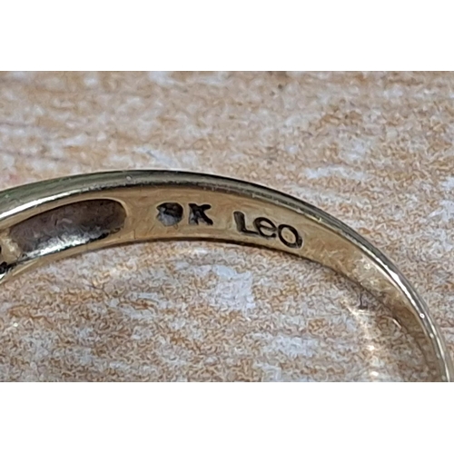 40 - 9ct yellow gold ring with a large CZ and smaller stones to both shoulders, 

3 grams gross