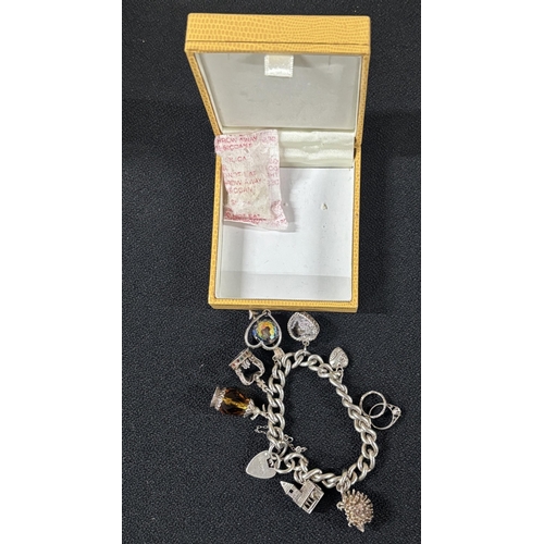 28 - Silver charm bracelet with some Silver charms 

58.3g gross